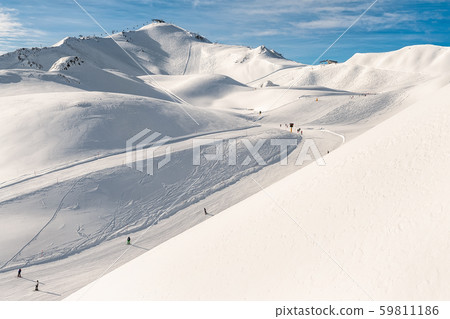 Scenic valley of hilghland alpine mountain winter resort on bright sunny day. Wintersport scene with Scenic valley of hilghland alpine mountain winter resort on bright sunny day. Wintersport scene with 59811186