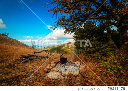 Bowler hat over a campfire in the fall 59811476