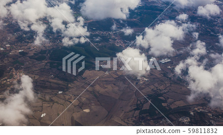 View from the porthole of an airplane. Clouds over Lisbon. View from the porthole of an airplane. Clouds over Lisbon. 59811832