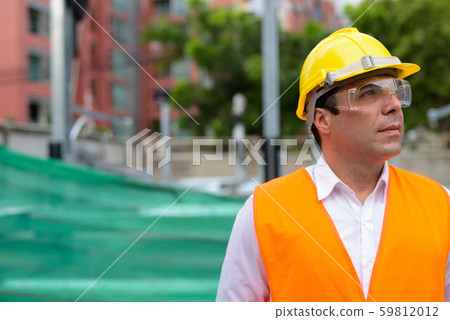 Handsome Persian man construction worker at the construction sit Handsome Persian man construction worker at the construction sit 59812012