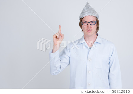 Young man doctor with tinfoil hat pointing up 59812910