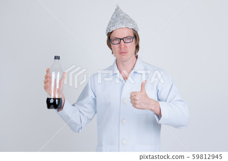 Young man doctor with tinfoil hat holding bottle of soda and giving thumbs up Young man doctor with tinfoil hat holding bottle of soda and giving thumbs up 59812945