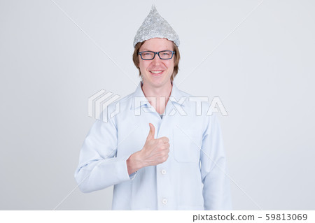 Happy young man doctor with tinfoil hat giving thumbs up Happy young man doctor with tinfoil hat giving thumbs up 59813069