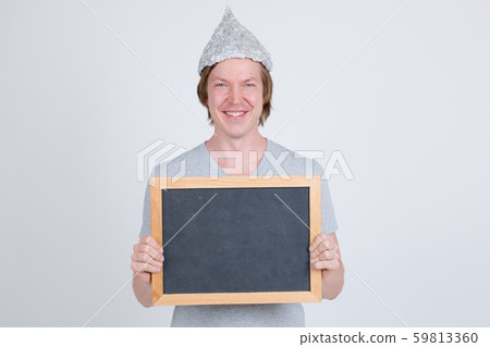 Happy young man with tin foil hat holding blackboard 59813360