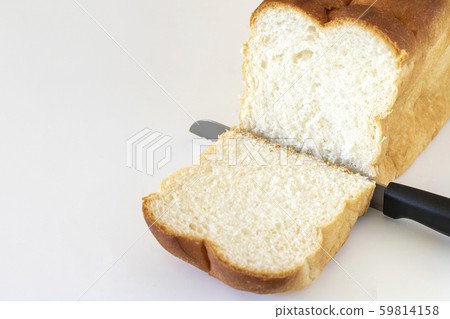A loaf of bread and a bread knife 59814158