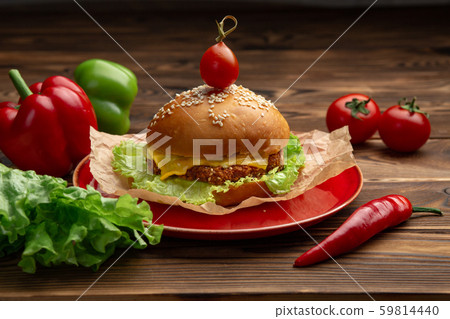 hamburger with meatballs and cheese in a red plate 59814440