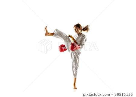 Confident junior in kimono practicing hand-to-hand combat, martial arts Confident junior in kimono practicing hand-to-hand combat, martial arts 59815136