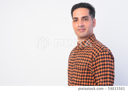 Closeup profile view of handsome Persian hipster man looking at camera Closeup profile view of handsome Persian hipster man looking at camera 59815501