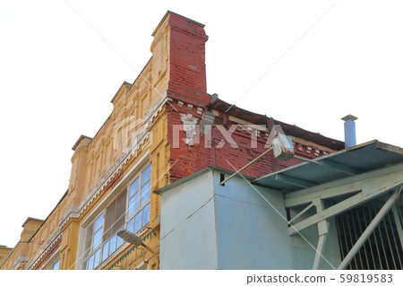 Old yellow brick industrial building 59819583