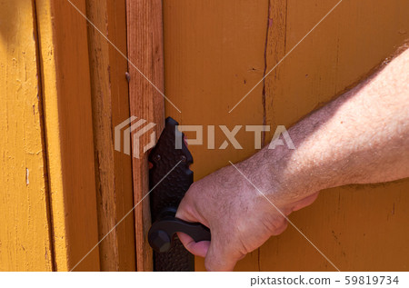 Hand holding a door handle Hand holding a door handle 59819734