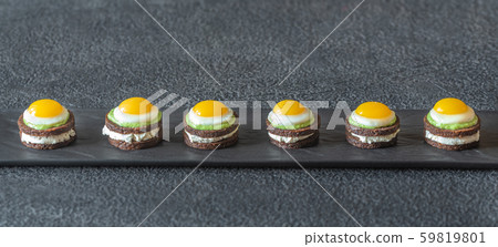 Canape with fried quail eggs 59819801