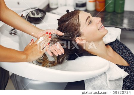 Woman washing head in a hairsalon Woman washing head in a hairsalon 59820724