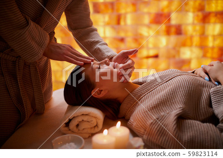 attractive young girl having face massage in spa salon attractive young girl having face massage in spa salon 59823114