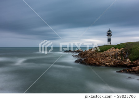 Lighthouse at sunset with cloudy sky and clear horizon, long exposure Lighthouse at sunset with cloudy sky and clear horizon, long exposure 59823706