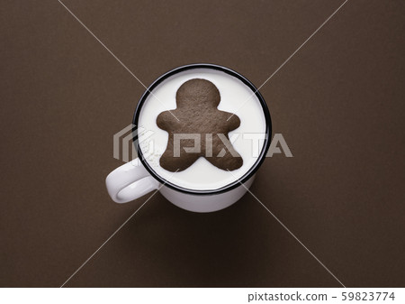Gingerbread man inside milk cup. Milk and cookies. 59823774