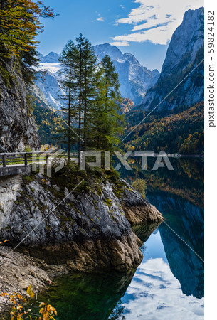 Peaceful autumn Alps mountain lake with clear Peaceful autumn Alps mountain lake with clear 59824182