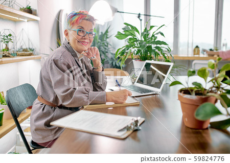 Gorgeous caucasian business woman sit in personal green office Gorgeous caucasian business woman sit in personal green office 59824776