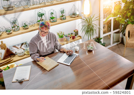Beautiful woman in blazer and glasses in office, snapshot from above Beautiful woman in blazer and glasses in office, snapshot from above 59824801
