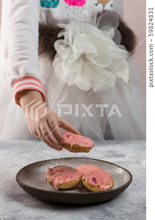 Girl grabbing a cranberry cookie 59824831