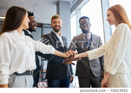 Handsome people of african and caucasian appearances joined hands in pile Handsome people of african and caucasian appearances joined hands in pile 59824892