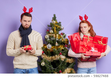 Dissatisfied man with small gift box 59827488