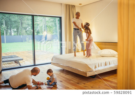 Family On Vacation, spend free time jumping on bed, playing 59828091