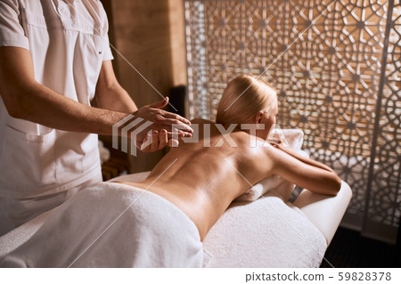 Charming pretty woman relaxing in beauty spa salon 59828378