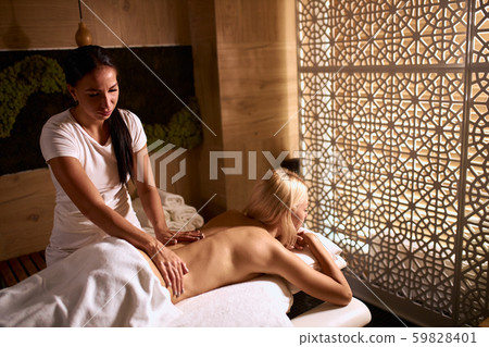 Beautiful woman relaxing with hand massage at beauty spa 59828401