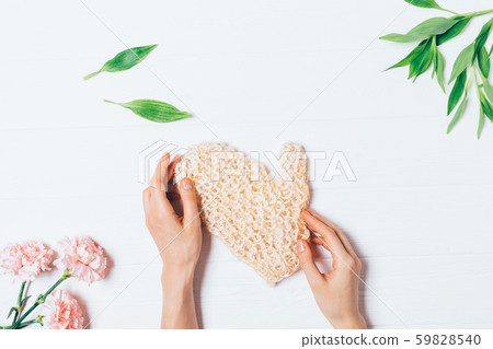 Female hands holding massage body washcloth Female hands holding massage body washcloth 59828540