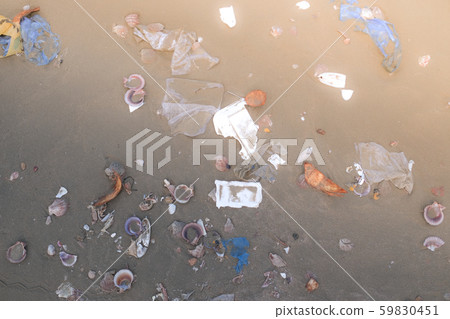 Trash, plastic, garbage, bottle, bag... environmental pollution on sandy beach. Royalty high-quality stock photo image of trash, plastic bag, bottle on beach. Waste that polluted the ocean environment Trash, plastic, garbage, bottle, bag... environmental pollution on sandy beach. Royalty high-quality stock photo image of trash, plastic bag, bottle on beach. Waste that polluted the ocean environment 59830451