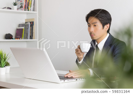 Asian Businessman Drink Coffee in Break Time with Tree Foreground Asian Businessman Drink Coffee in Break Time with Tree Foreground 59831164