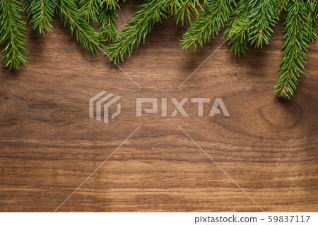 Top view of green spruce twigs on walnut wood surface Top view of green spruce twigs on walnut wood surface 59837117