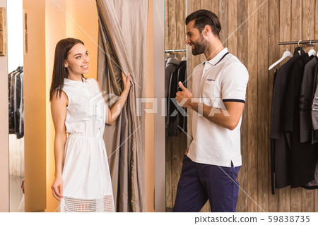 Young adult husband and wife in fitting room Young adult husband and wife in fitting room 59838735