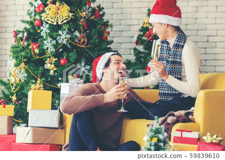Merry Christmas. Young couple celebrating Merry Christmas. Young couple celebrating 59839610