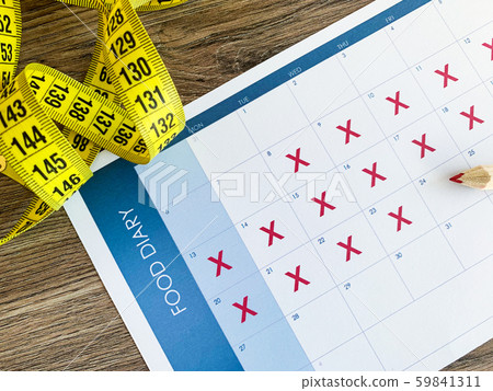 Diet plan concept. Measuring tape and diet plan on wooden background. 59841311