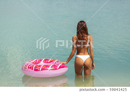 Woman in the Water with a Rubber Ring. 59841425
