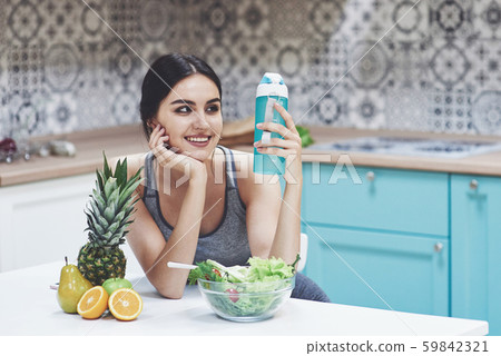 Beautiful woman with healthy food fruit in the kitchen Beautiful woman with healthy food fruit in the kitchen 59842321