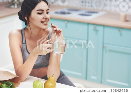 Beautiful woman with healthy food fruit in the kitchen Beautiful woman with healthy food fruit in the kitchen 59842416
