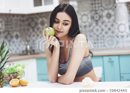 Beautiful woman with healthy food fruit in the kitchen 59842443