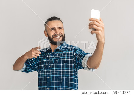 Adult bearded man point at you, holding smartphone Adult bearded man point at you, holding smartphone 59843775