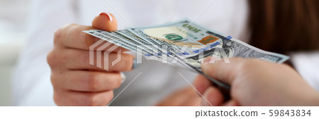 Male arm pay bunch of hundred dollars bills Male arm pay bunch of hundred dollars bills 59843834