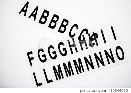 Black capitalize letter on white table background. Black capitalize letter on white table background. 59844010