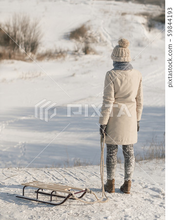 Woman with Sled Outdoors Woman with Sled Outdoors 59844193