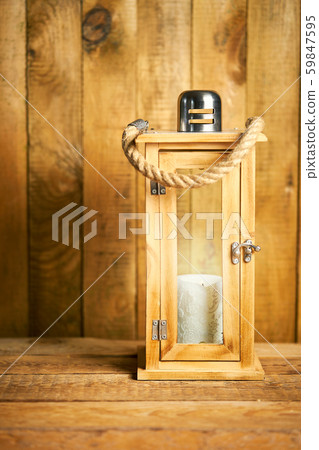 Beautiful wooden lantern on background of old wooden boards Beautiful wooden lantern on background of old wooden boards 59847595