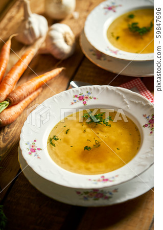 Closeup of delicious home made broth on old wooden table 59847696