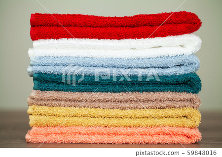 Stack colorful towels in bathroom on table 59848016
