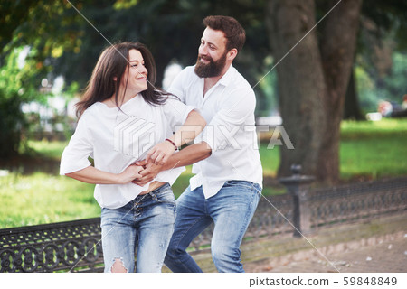 Romantic couple enyojing in moments of happiness in the park. Lifestyle concept love and tenderness Romantic couple enyojing in moments of happiness in the park. Lifestyle concept love and tenderness 59848849