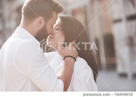 Beautiful happy couple hugging on the city street.Lifestyle concept love and romance Beautiful happy couple hugging on the city street.Lifestyle concept love and romance 59849058