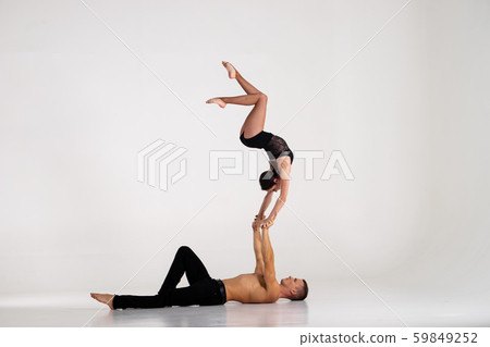 Duo Of Acrobats Showing hand to hand Trick, Isolated On White 59849252