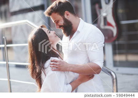 Beautiful happy couple hugging on the city street.Lifestyle concept love and romance Beautiful happy couple hugging on the city street.Lifestyle concept love and romance 59849444